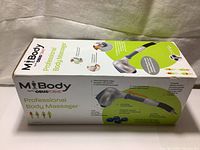 Box showing product branding and image of the massager device with details.