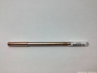 Full length photo of the eye pencil showing the metallic body and rose gold end cap.