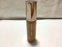 Front view of Nude By Nature foundation bottle showing brand and product name.