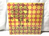 Front cover shows vibrant yellow, orange, and pink geometric design with stylized tree and faces, and Woodstock Choralaires title.