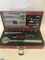 Open metal case showing all included tools arranged inside.