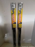 Two packaged TriplEdge Premium Silicone 22-inch wiper blades standing upright showing front packaging with branding and product specifications
