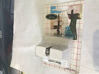 Front angle of packaged wall-mounted knife sharpener with bottle opener showing brand 'Star' and product features.