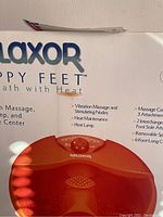 Close up of Relaxor Happy Feet branding and footbath with visible heat lamps and control dial.