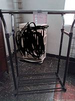 Standing clothes rack showing the overall frame including upper hanging bar and lower rack.