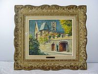 Framed oil painting showing a Paris street scene with a building and figure, carved decorative frame, some paint loss visible.