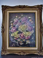 Full front view of the framed oil painting showing the floral bouquet and ornate gold frame with minor wear.