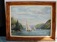 Frontal image of the framed oil painting showing sailboats on water under a cloudy sky with trees and hills at riverbanks.