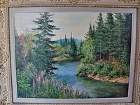 Full front view of the framed oil painting showing the landscape image and ornate plaster frame.