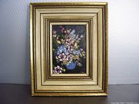 Frontal image of the floral oil painting in a gold frame.