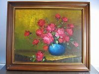 Frontal view of the framed oil painting showing pink roses in a blue vase with an olive green background.