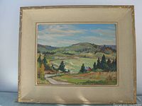 Full view of framed oil painting showing rural landscape scene with hills and fields.