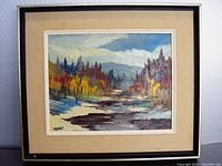 Framed oil painting on board showing a fall landscape with colorful trees, a river, and distant hills under sky.