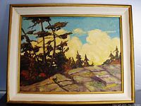 Full view of the framed oil painting showing the summer scene with rocks, trees, and clouds.