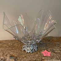 Front view of the clear acrylic bowl with the silver-tone grapevine stand