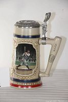 Left side view of the baseball stein showing Babe Ruth batting illustration and decorative details.