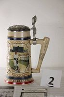 Ceramic baseball stein with image of Lou Gehrig batting, showing handle, pewter lid, and color accents.