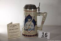 Front view of Lou Gehrig stein with certificate, showing portrait, siganture on handle and star motifs.