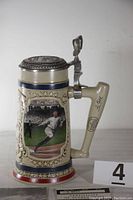 Side view of the Ty Cobb stein showing the colorful player image and ornate patterned frame.