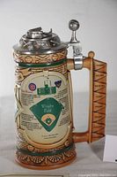 Front view showing baseball diamond diagram, sculpted baseball motifs, and wood-toned handle with team names.