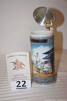 Budweiser Babe Ruth stein with certificate of authenticity to the left, showing hinged pewter lid open exposing interior.