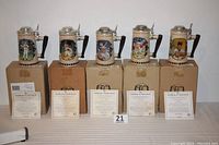 Front view of all five Cal Ripken Jr. collector's steins with their boxes and certificates of authenticity, showing detailed artwork and signatures on handles.