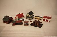 Full lot showing about 7 HO scale buildings including house, barn, and various small buildings