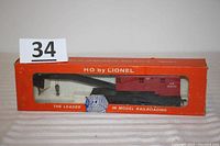 HO scale Lionel crane car in original orange box with display window and labeling.
