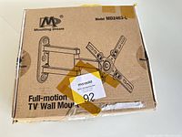 Closed cardboard box labeled Mounting Dream Model MD2463-L Full-motion TV Wall Mount
