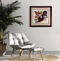 The framed watercolor painting hung on a white wall above a modern chair and ottoman, showing size scale and room setting.