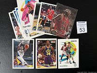 Image showing various basketball trading cards collected in a pile, highlighting multiple players and teams.