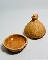 Two-piece handmade garlic baker from Mexico, showing garlic bulb-shaped lid and round glazed base dish.