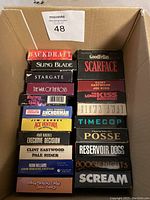 Photo of 21 VHS movies stacked showing titles on spines.