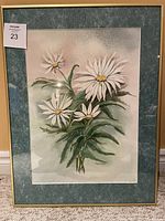 Full view of framed watercolour painting showing daisies, green mat, and gold frame.