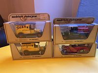 Front view of the four Matchbox Models of Yesteryear die-cast cars in original packaging, stacked in two pairs. Visible model types and paint schemes on the vehicles.