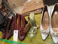 All five pairs of women's footwear displayed, showing variety in styles and colors, including Ghirardelli and Pelle Moda brands.