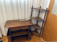 Overall view of the two pieces together showing the side table with drawer and shelving next to the corner shelf.