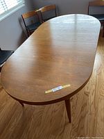 Top-down view of oval teak table showing surface and shape