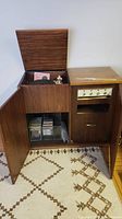 Open console cabinet showing Garrard turntable inside and storage compartment below