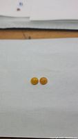 Photo shows a pair of round cabochon honey jade gemstones, butterscotch color, placed on white background for size and color reference.