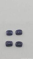 Four natural deep purple opal gemstones laid flat, showing cushion cabochon shape and size.