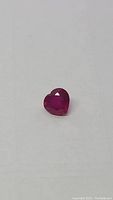 Front view of heart-shaped ruby on white background