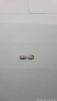 Pair of cushion cabochon Mexican cinnabar gemstones showing size and shape.