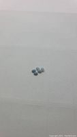 Photo showing six small oval natural blue opal stones on a plain white background.