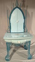 Front view of Frozen themed child's vanity with closed decorative doors featuring snowflake design.
