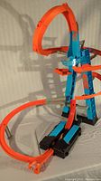 Full view of Hot Wheels Tower playing set showing tall blue and orange track with loops and ramps on white backdrop