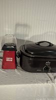 Lot with Rival roaster oven alongside Popflix hot air popcorn popper showing front view