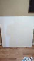 Front view of the magnetic whiteboard showing the full square white surface.