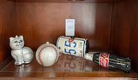 All four novelty clutch purses displayed together on shelf