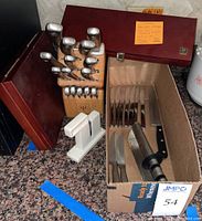 Overview of Wusthof block set, empty Henckels box, cardboard box with additional knives and two sharpeners